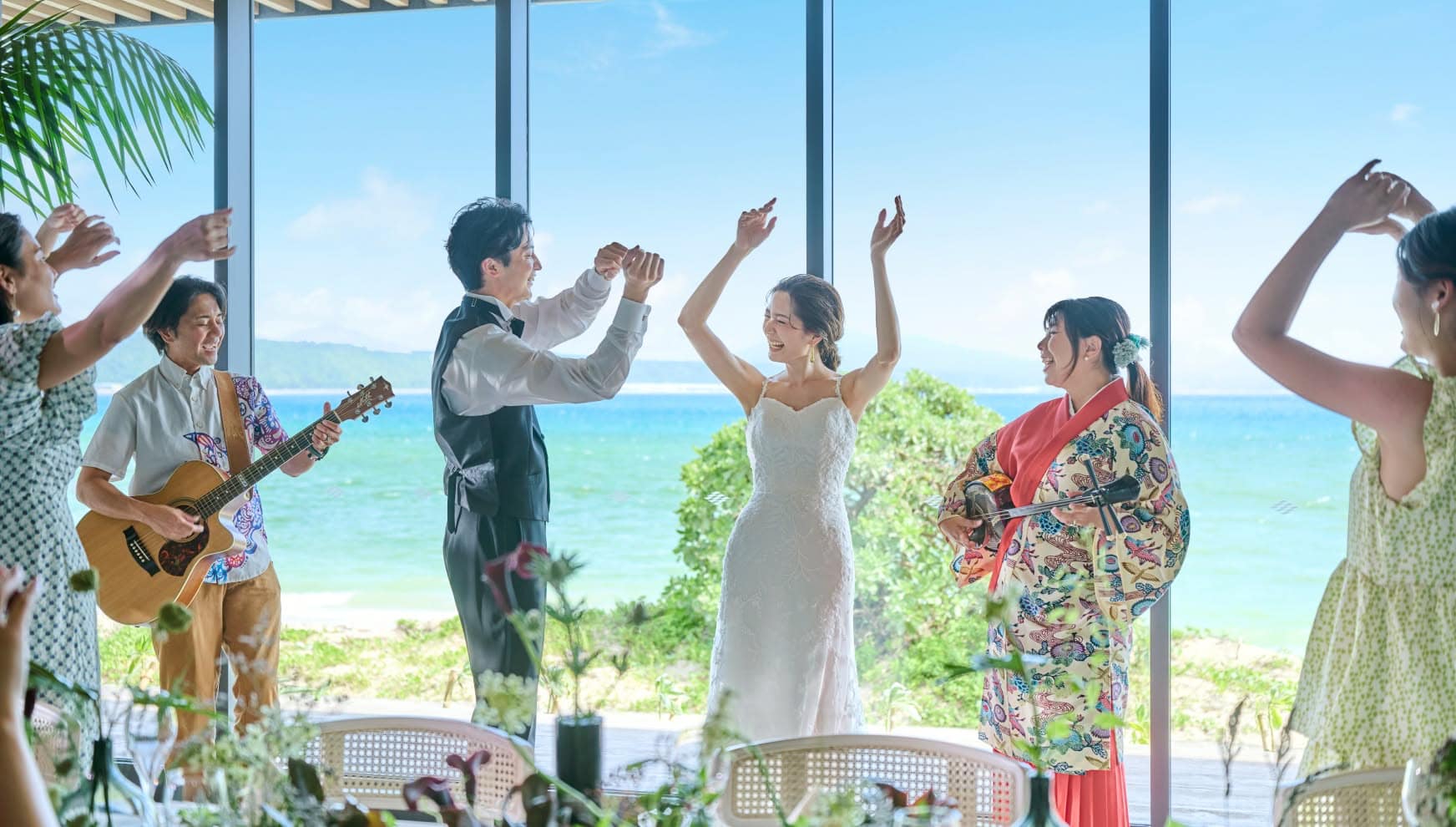 沖縄の海を背景にした結婚式のダンスと音楽のシーン.